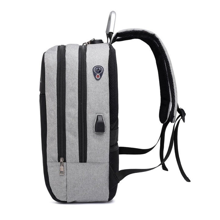Modern grey anti-theft security backpack with hidden zippers & USB port, suitable for laptops & travel.