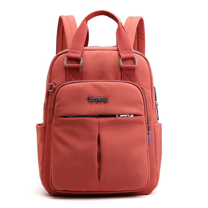 Black water-resistant anti-theft backpack with USB charging port. Perfect for travel & daily commute.