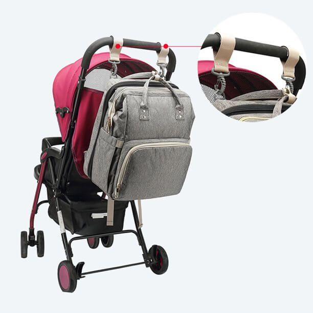 Foldable baby bassinet fully deployed from a waterproof nappy backpack, ready for infant rest.