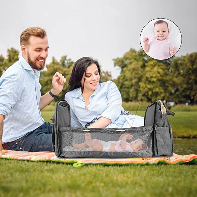 Open nappy backpack showing organized multi-pocket interior for baby essentials & accessories.
