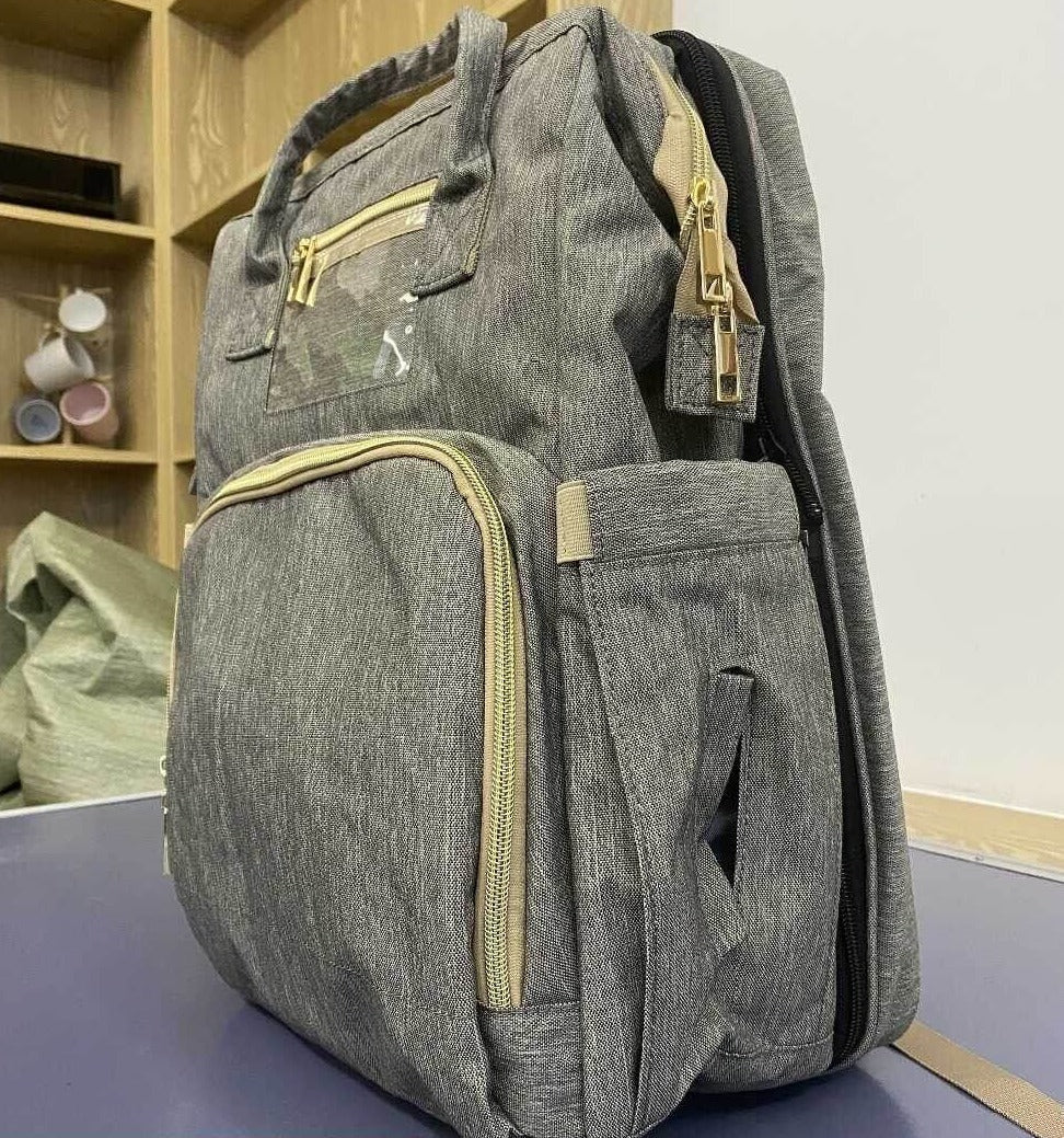 Waterproof material close-up of a convertible nappy backpack, ideal for spills & travel.