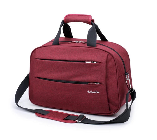 Ergonomic, retractable handle of the lightweight unisex convertible carry-on luggage bag for easy rolling.
