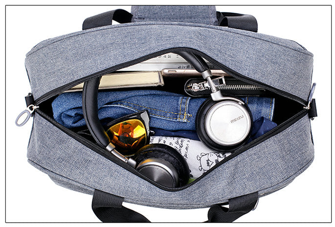 Close-up of sturdy zippers on a lightweight, airline-approved unisex convertible carry-on travel bag.