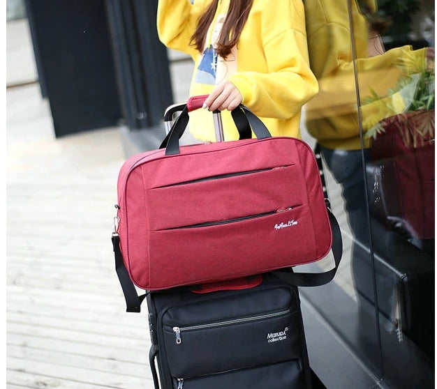 Durable, water-resistant fabric of a black unisex convertible carry-on travel bag, built for adventure.