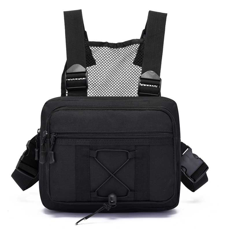 Hiker wearing a multi-pocket tactical chest rig bag, hands-free for adventure. Durable & water-resistant outdoor gear.