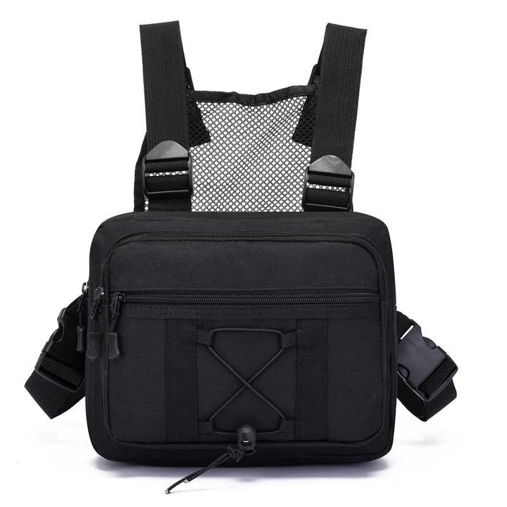 Hiker wearing a multi-pocket tactical chest rig bag, hands-free for adventure. Durable & water-resistant outdoor gear.