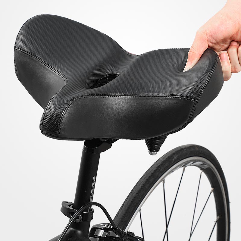 Wide bicycle saddle with ergonomic design & supportive cushioning for superior cycling comfort.