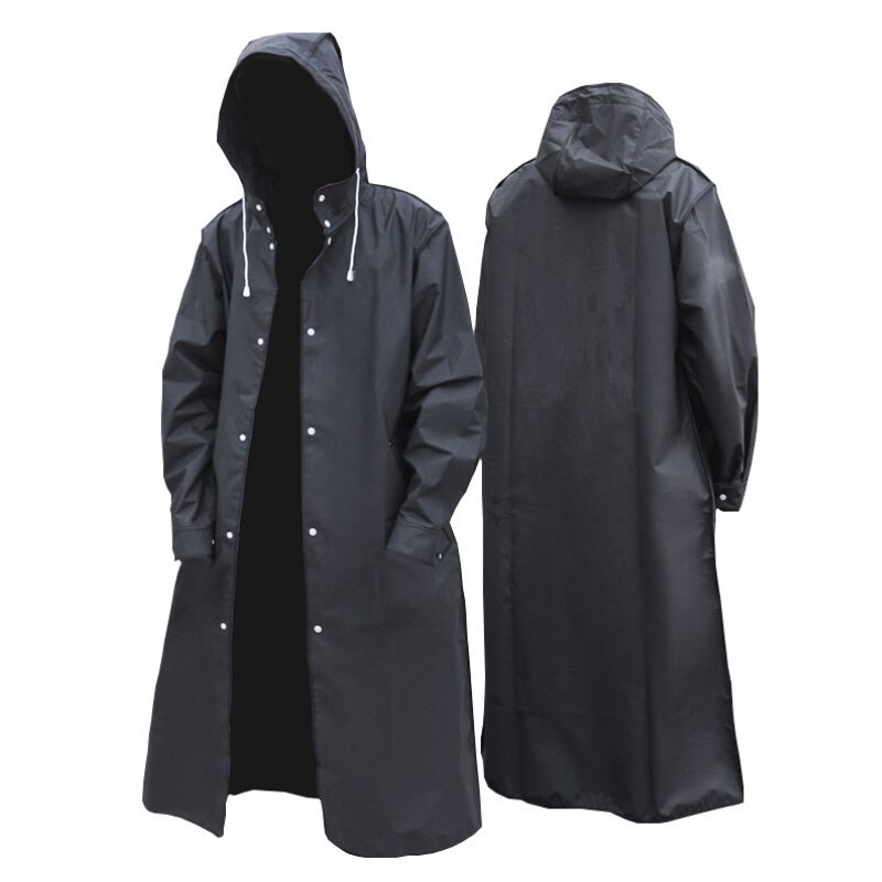 Adventurer hiking in a lightweight, windproof unisex long raincoat, staying dry in the rain. Perfect outdoor gear.