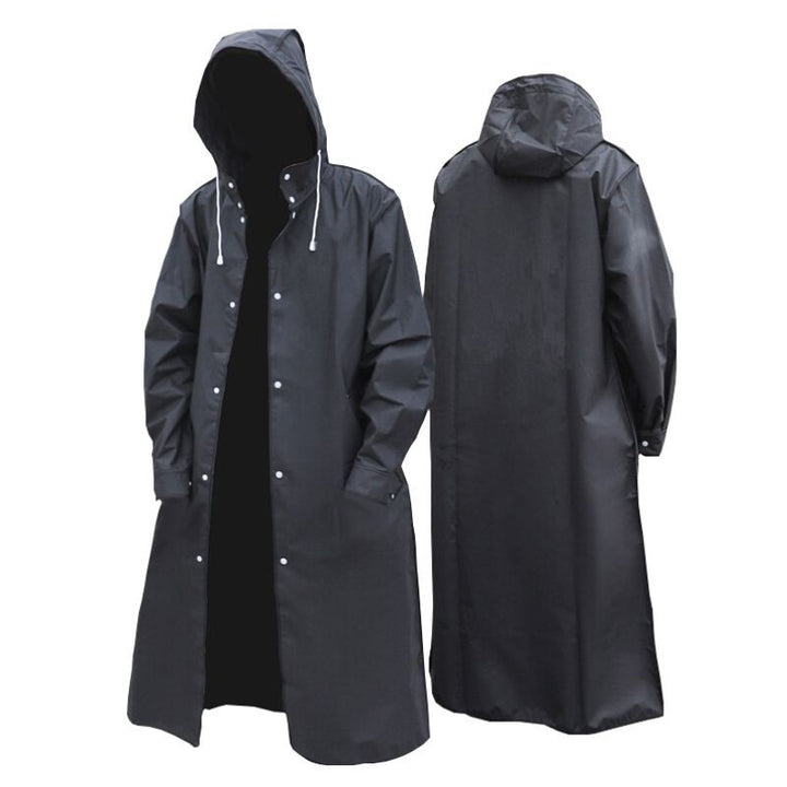 Adventurer hiking in a lightweight, windproof unisex long raincoat, staying dry in the rain. Perfect outdoor gear.
