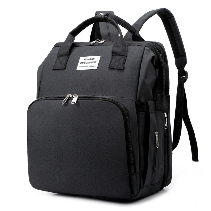 Unisex portable baby bed & diaper bag backpack, ideal for travel and changing station needs.