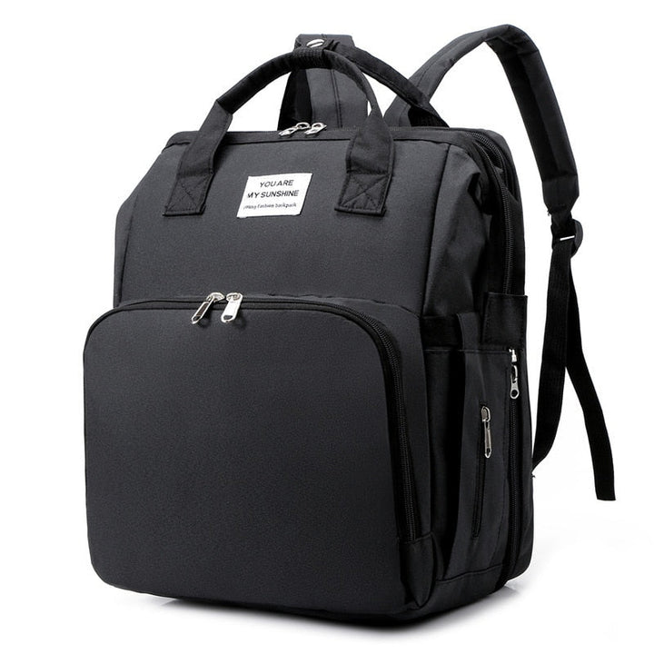 Unisex portable baby bed & diaper bag backpack, ideal for travel and changing station needs.