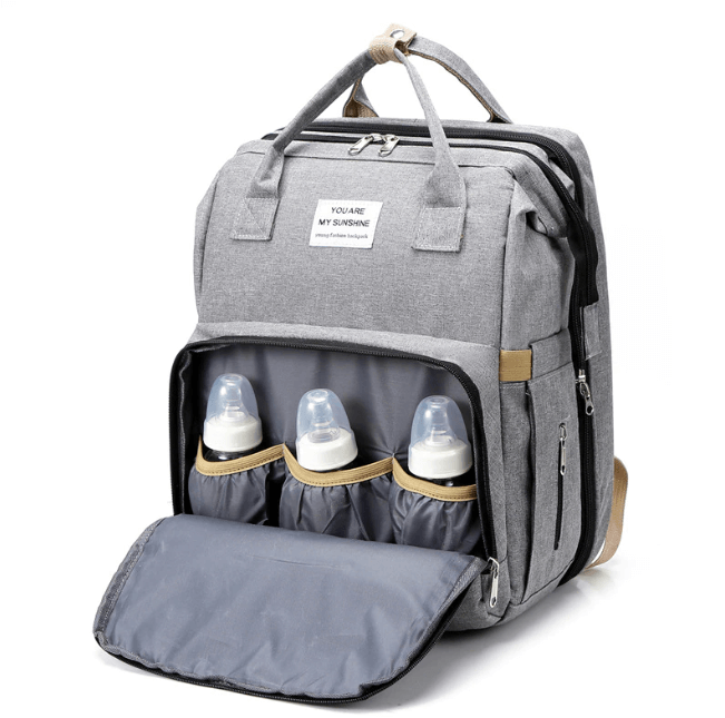 Convenient multi-function baby bag for travel, featuring a portable bed and diaper changing area.