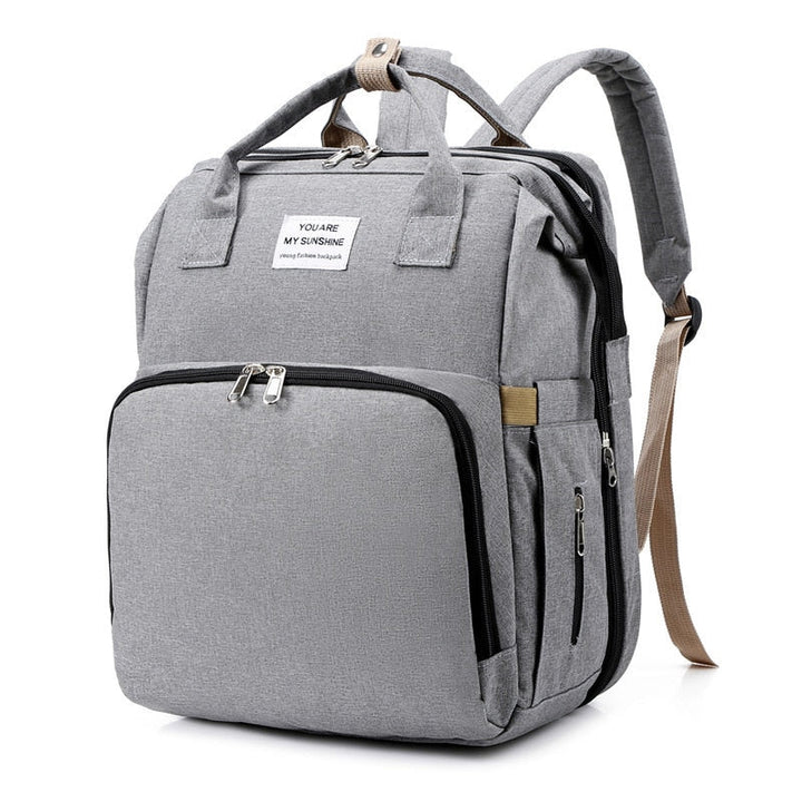 Waterproof unisex diaper bag, perfect as a travel backpack and a convenient baby bed for newborns.