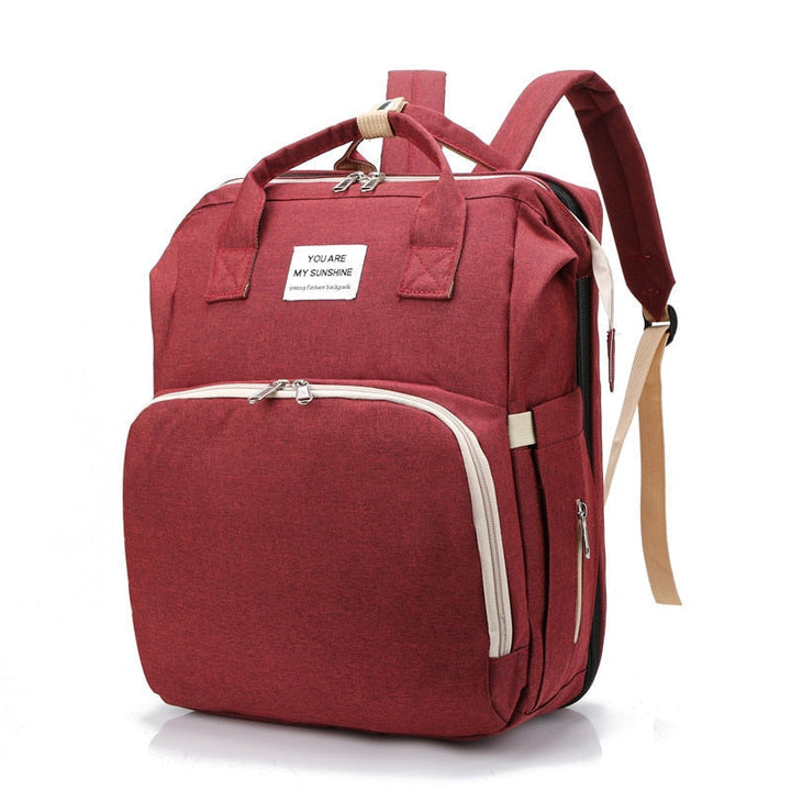Newborn multi-function diaper bag, converting into a portable bed, essential baby gear for travel.