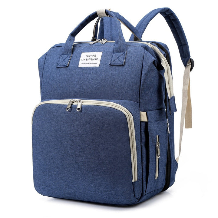 Unisex travel backpack with built-in portable baby bed and changing mat for on-the-go parenting.