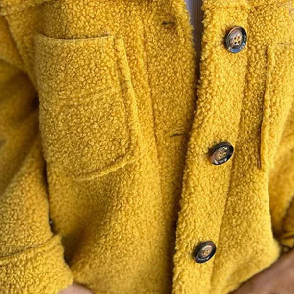 Stylish women's winter teddy coat with chic lapel, offering warmth & comfort for cold weather fashion.