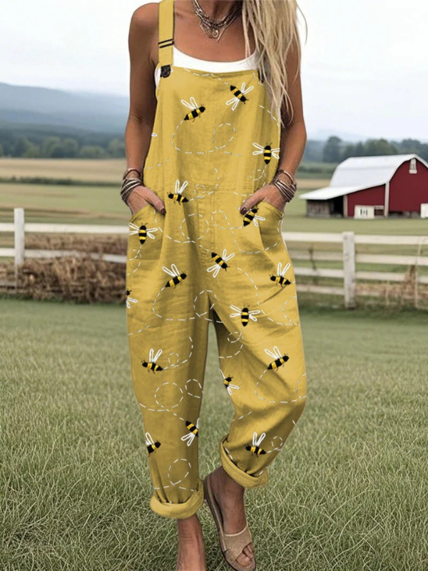 Whimsical women's yellow jumpsuit with honeybee print, perfect for summer meadow adventures. Comfortable & elegant.