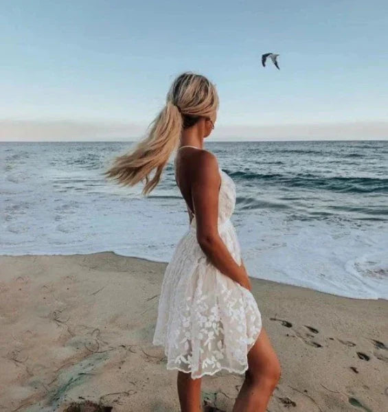 Elegant women's V-neck halter mini cocktail dress with a beautiful floral pattern, ideal for summer events.