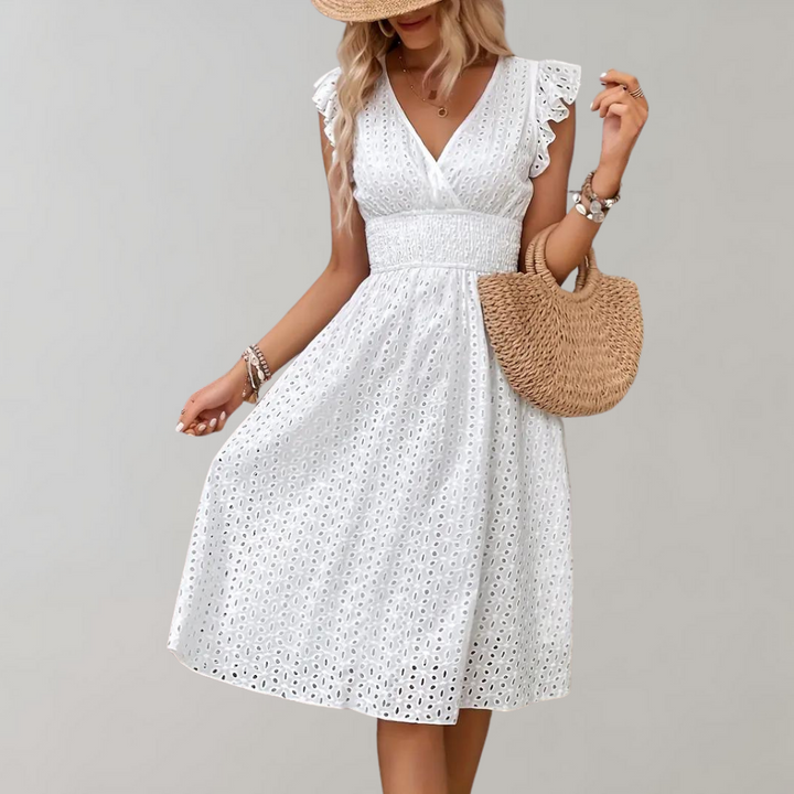 Stylish women's white flowy summer dress featuring chic ruffled sleeves. Ideal for a comfortable day out.