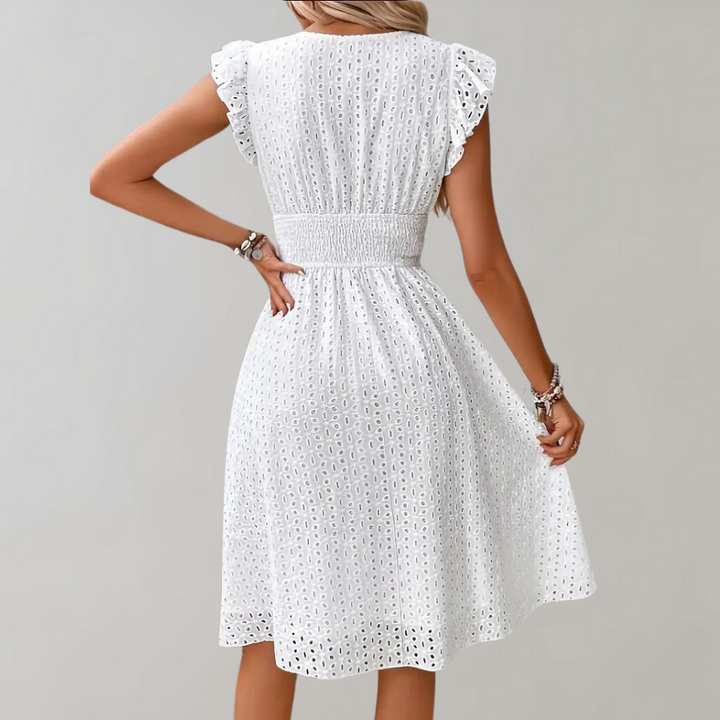 Beautiful white summer dress for women. Midi length, with charming ruffled sleeves, perfect for vacation fashion.