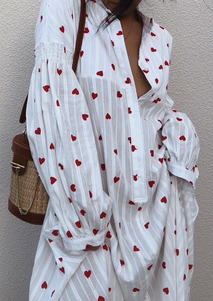 Women's flowy white summer maxi dress, featuring whimsical heart embroidery & stylish balloon sleeves.