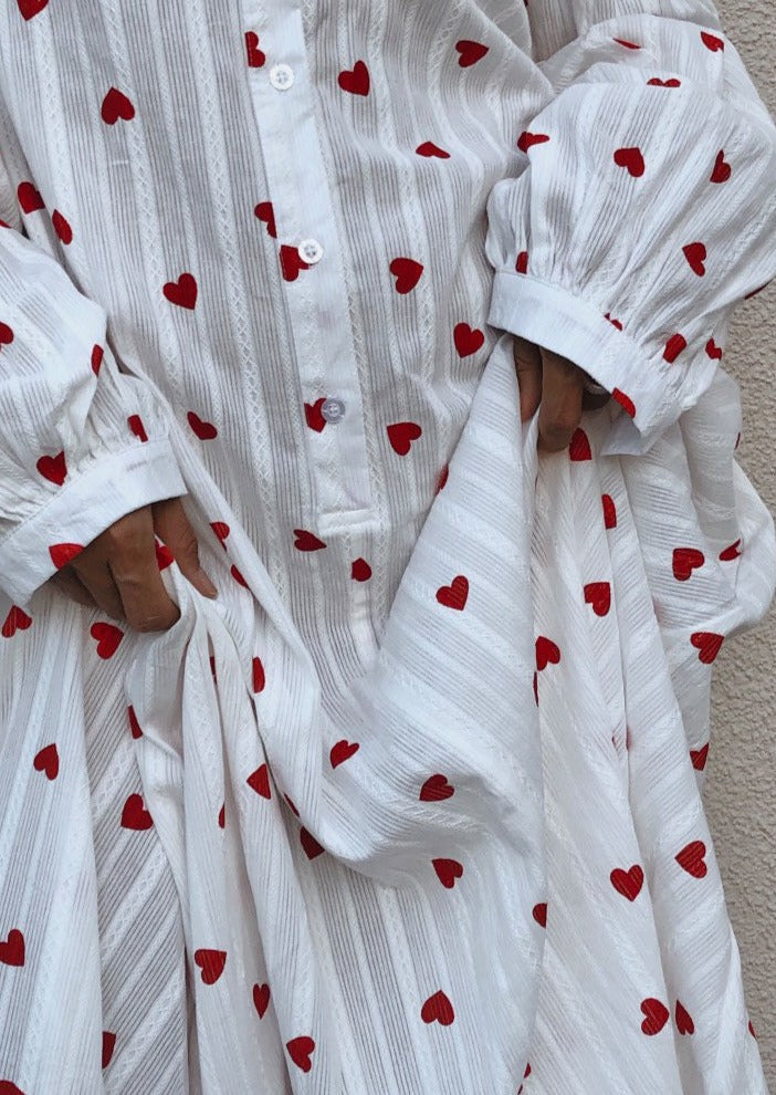 Romantic white oversized maxi dress with embroidered hearts, balloon sleeves, ideal for summer casual.
