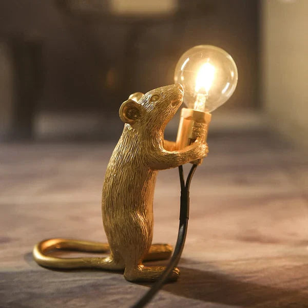 Whimsical mouse table lamp, a gold & white resin desk lamp adding unique animal decor to any space.