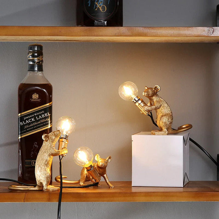 Unique SqueakLight mouse lamp, a gold resin table lamp adding whimsical charm to any room.