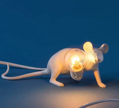 Detailed resin mouse lamp, a whimsical gold table lamp creating a unique home accent.