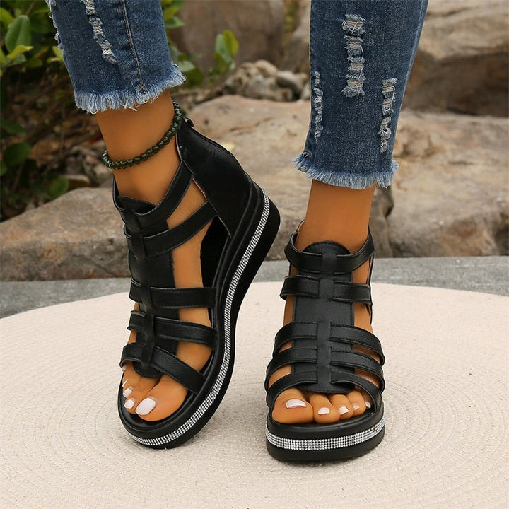 Side profile of a white strappy platform sandal, emphasizing the platform and heel