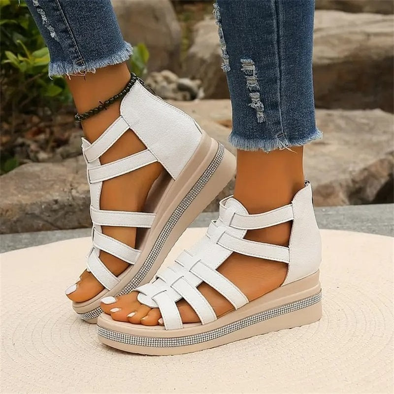 Close-up of white strappy platform sandal showing ankle strap detail and sole