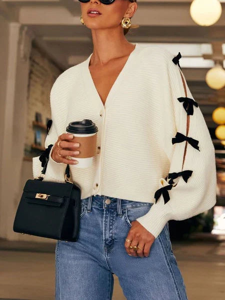 White women's bow sleeve cardigan, chic & comfortable for everyday style and versatile layering.