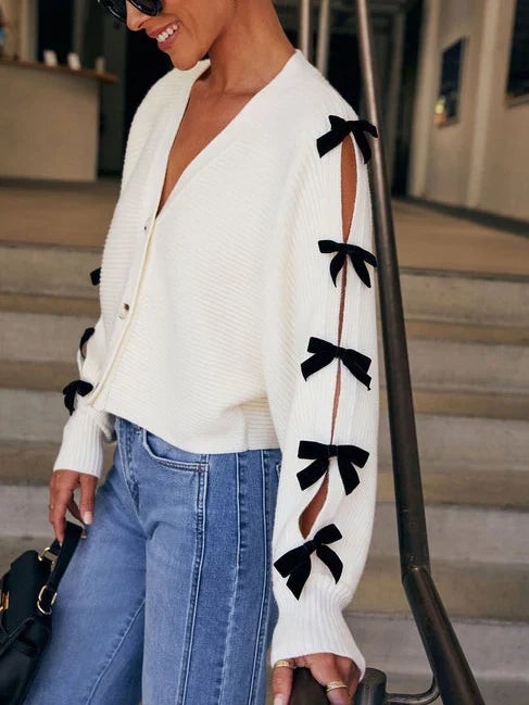 Stylish women's white cardigan with elegant bow sleeves, perfect for casual wear & layered fashion.