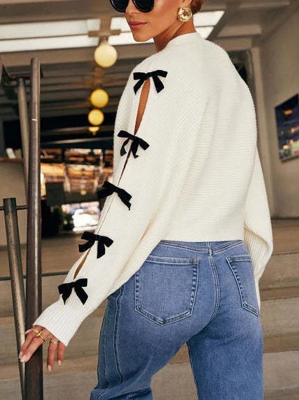 Comfortable white women's cardigan featuring unique bow sleeve detail, ideal for a chic layered look.