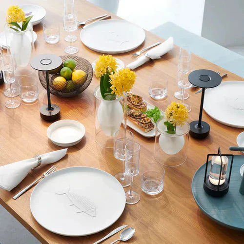 Silver wireless lamp, portable & rechargeable, a modern lighting solution for stylish living rooms.
