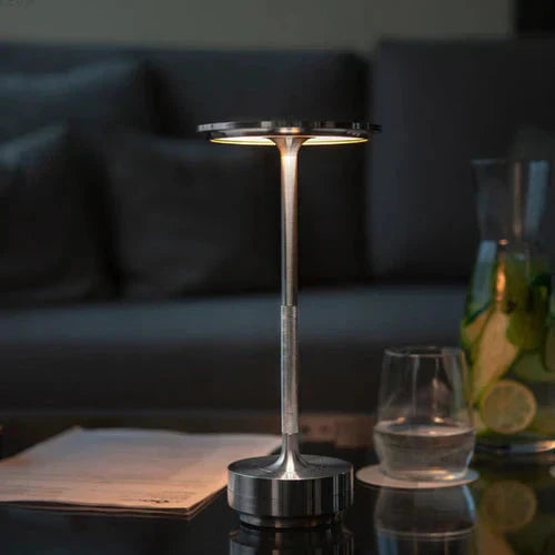 Sleek black wireless table lamp, USB rechargeable, providing dimmable ambient light for home decor.