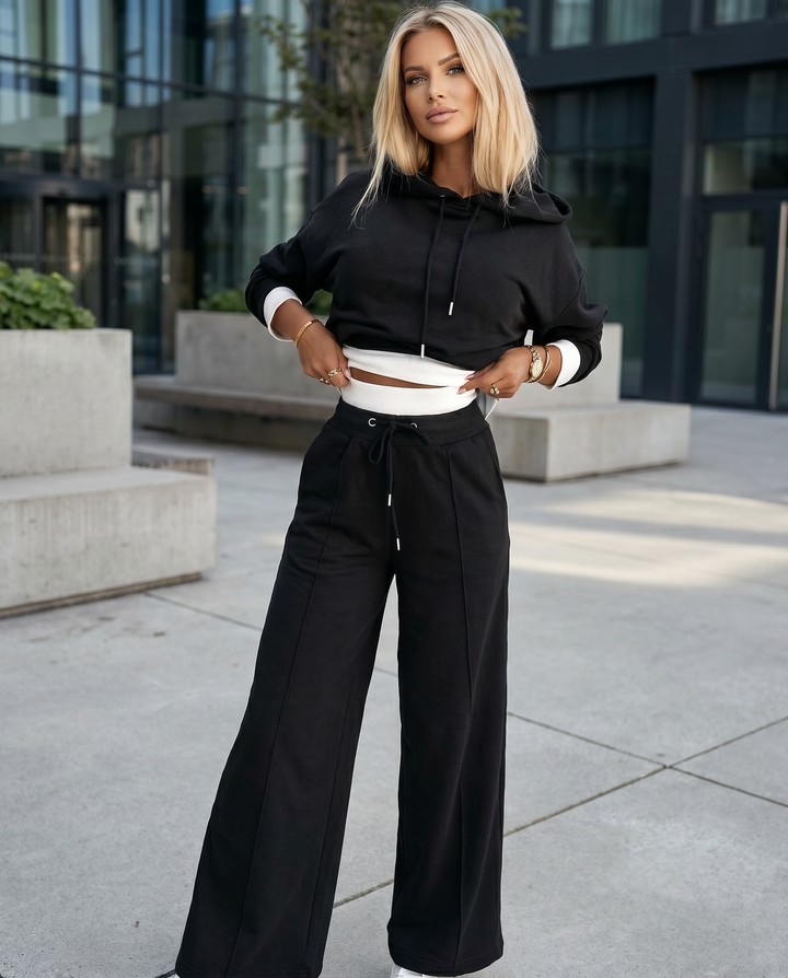 Cozy women's two-piece tracksuit featuring a comfy hoodie and stylish wide-leg trousers, ideal for casual wear.