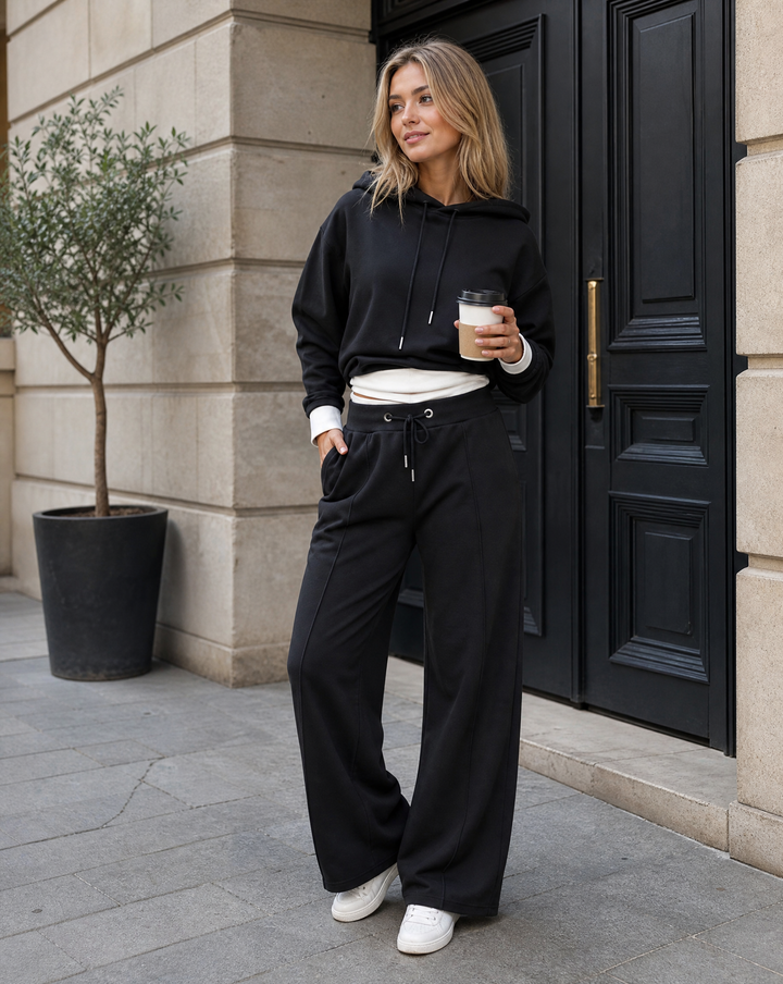 Fashionable women's wide-leg tracksuit set with a relaxed hoodie, great for sporty chic loungewear.