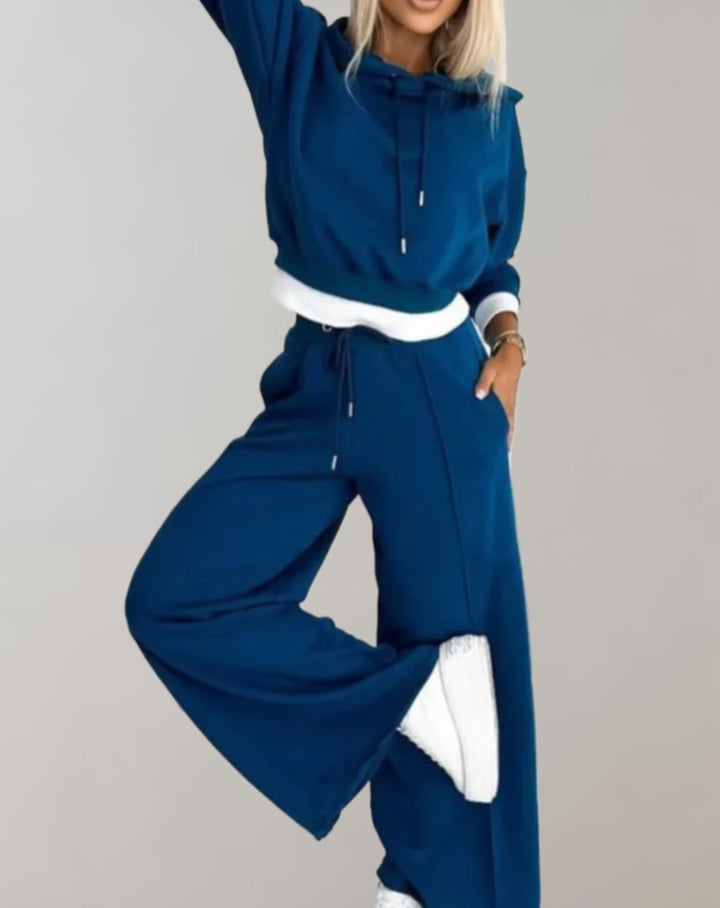 Soft women's two-piece casual set with a comfortable hoodie and flowing wide-leg pants for effortless style.