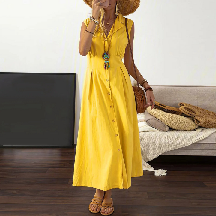 Stylish women's midi dress, A-line cut, sleeveless design with collared V-neck and button detailing. Cotton blend.