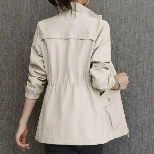 Close-up of a women's spring trench coat highlighting the adjustable waist for a customizable fit and elegant style.