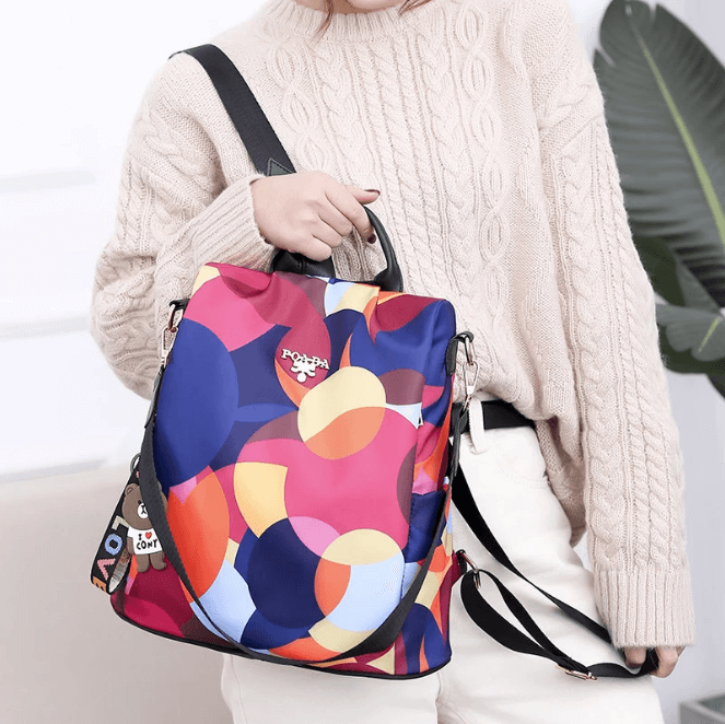 SafeHold women's anti-theft backpack in urban setting. Water-resistant, stylish, & perfect for secure city adventures.