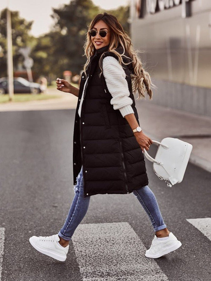 Comfortable Aurora hooded knee-length quilted bodywarmer vest for women, ideal casual fall & winter style.