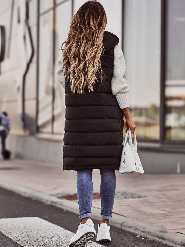 Aurora women's sleeveless knee-length quilted vest, a versatile and warm outerwear piece for cooler seasons.