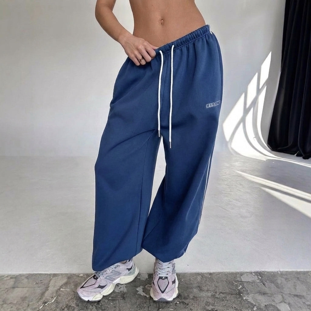 Women's baggy fit sweatpants with stylish side stripe, perfect for casual comfort & loungewear.