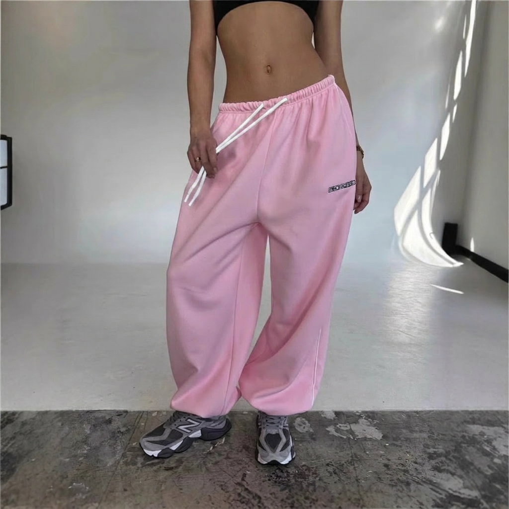Relaxed fit women's sweatpants featuring a stylish side stripe & drawstring, great for comfort.
