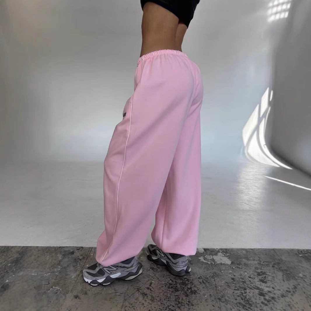 Stylish women's baggy sweatpants with a wide leg & side stripe, perfect for loungewear & casual outfits.