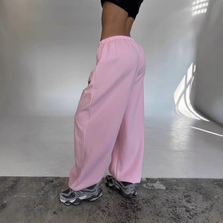Stylish women's baggy sweatpants with a wide leg & side stripe, perfect for loungewear & casual outfits.