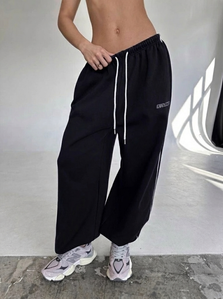 Casual women's drawstring sweatpants, relaxed baggy fit bottoms with a fashionable side stripe.