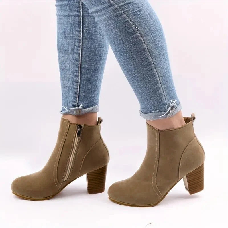 Stylish women's ankle boots with sturdy block heel & side zip, essential fall/winter fashion footwear.